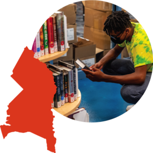 Collaged image showing the shape of Prince George's County in red-orange, next to a circular cropped photo of a young man looking at a book in the library.